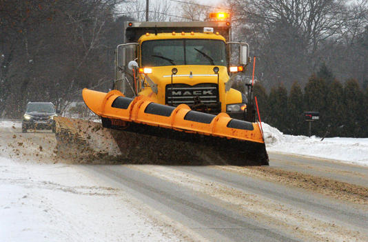 A PennDOT plow truck heads west while clearing snow on Route 5 in Girard Township on Jan. 16, 2025.