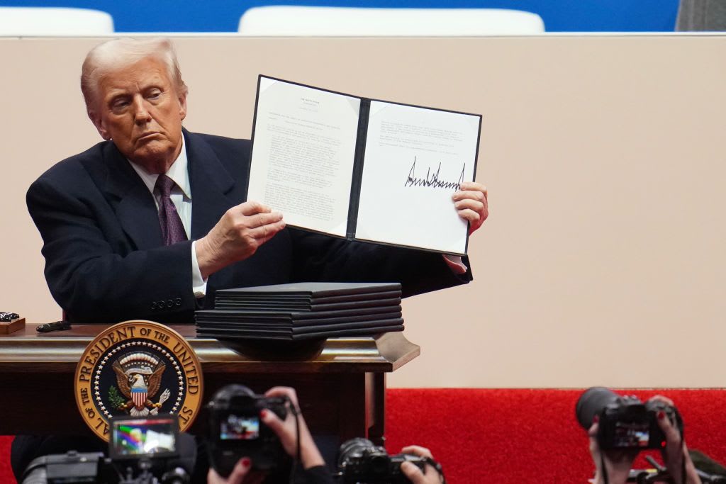 U.S. President Donald Trump holds up an executive order after signing it during an indoor inauguration parade at Capital One Arena on Jan. 20, 2025 in Washington, DC. (Christopher Furlong/Getty Images)