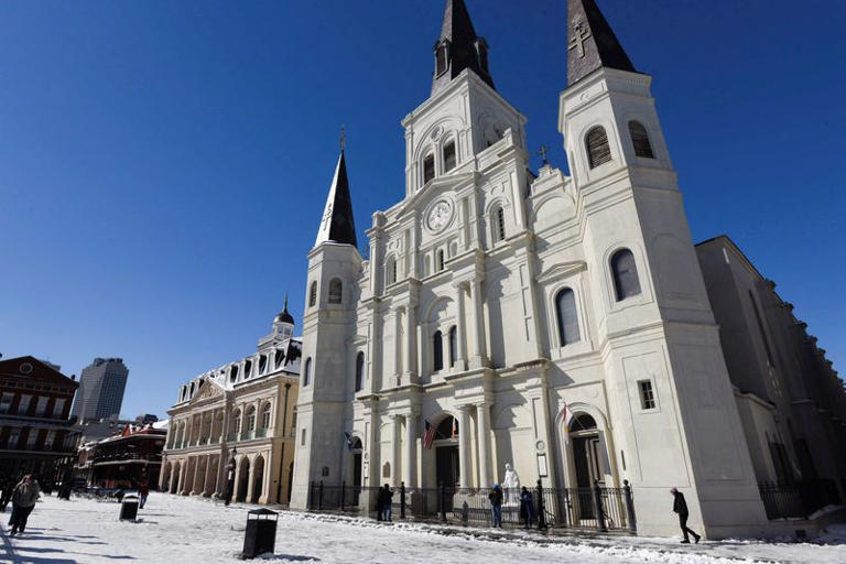 A mix of snow and ice covers the ground in front of St. Louis Cathedral in the French Quarter after a rare winter snowstorm churned across the U.S. Gulf Coast, in New Orleans, Louisiana, U.S. January 22, 2025. REUTERS/Shawn Fink