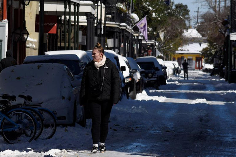 Abbie Goodwin walks after a rare winter snowstorm churned across the U.S. Gulf Coast, in New Orleans, Louisiana, U.S. January 22, 2025. REUTERS/Shawn Fink