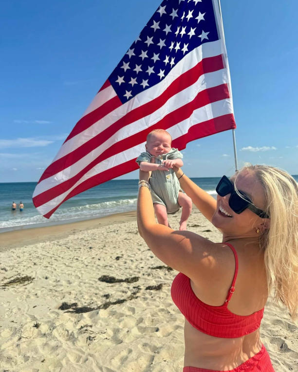 Karoline Leavitt holds up her one-month-old 