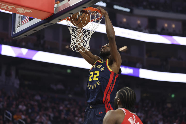 Golden State Warriors forward Andrew Wiggins (22) dunks the ball over Chicago Bulls forward Patrick Williams, bottom, during the first half of an NBA basketball game in San Francisco, Thursday, Jan. 23, 2025. (AP Photo/Jed Jacobsohn)