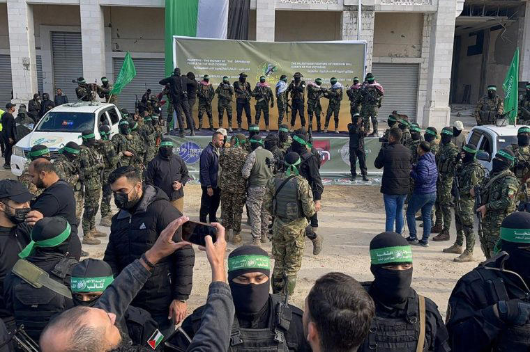 Hamas fighters gather at a square before handing over four Israeli hostages to the Red Cross in Gaza City (Photo: AFP via Getty)