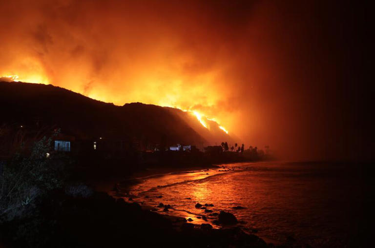 The Palisades fire burns along Pacific Coast Highway in Malibu on Tuesday. ((Wally Skalij / Los Angeles Times))