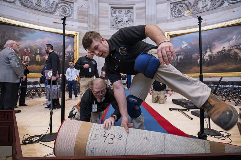 Organisers work to move the Inauguration Day swearing-in ceremony into the Capitol Rotunda due to expected cold weather in Washington, 18 January, 2025 J. Scott Applewhite/Copyright 2024 The AP. All rights reserved