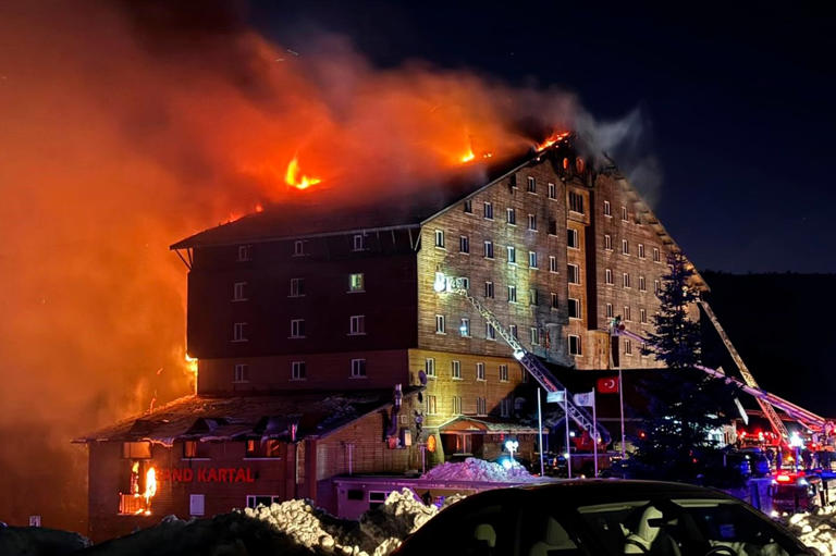 Firefighters work to extinguish a fire in a hotel at a ski resort of Kartalkaya in Bolu province, in northwest Turkey