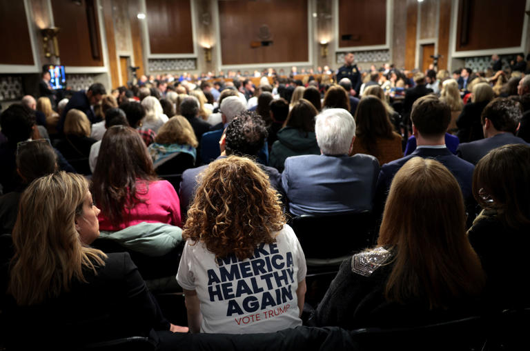 An audience members wears a "Make America Healthy Again" t-shirt as Kennedy testifies during his Senate Finance Committee confirmation hearing.