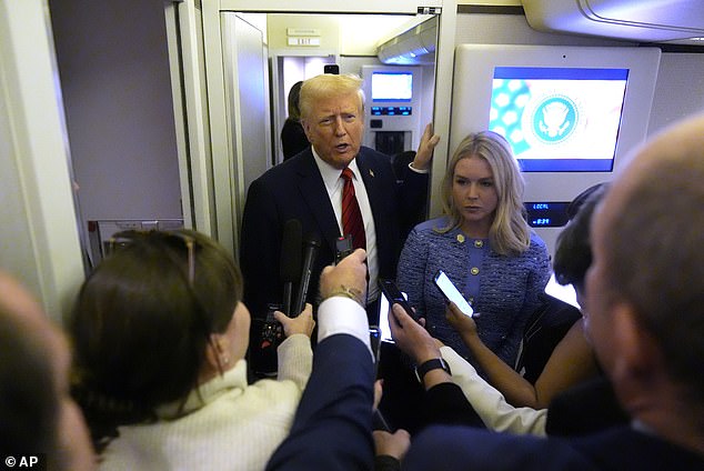 President Donald Trump speaks to reporters aboard Air Force One with White House press secretary Karoline Leavitt.