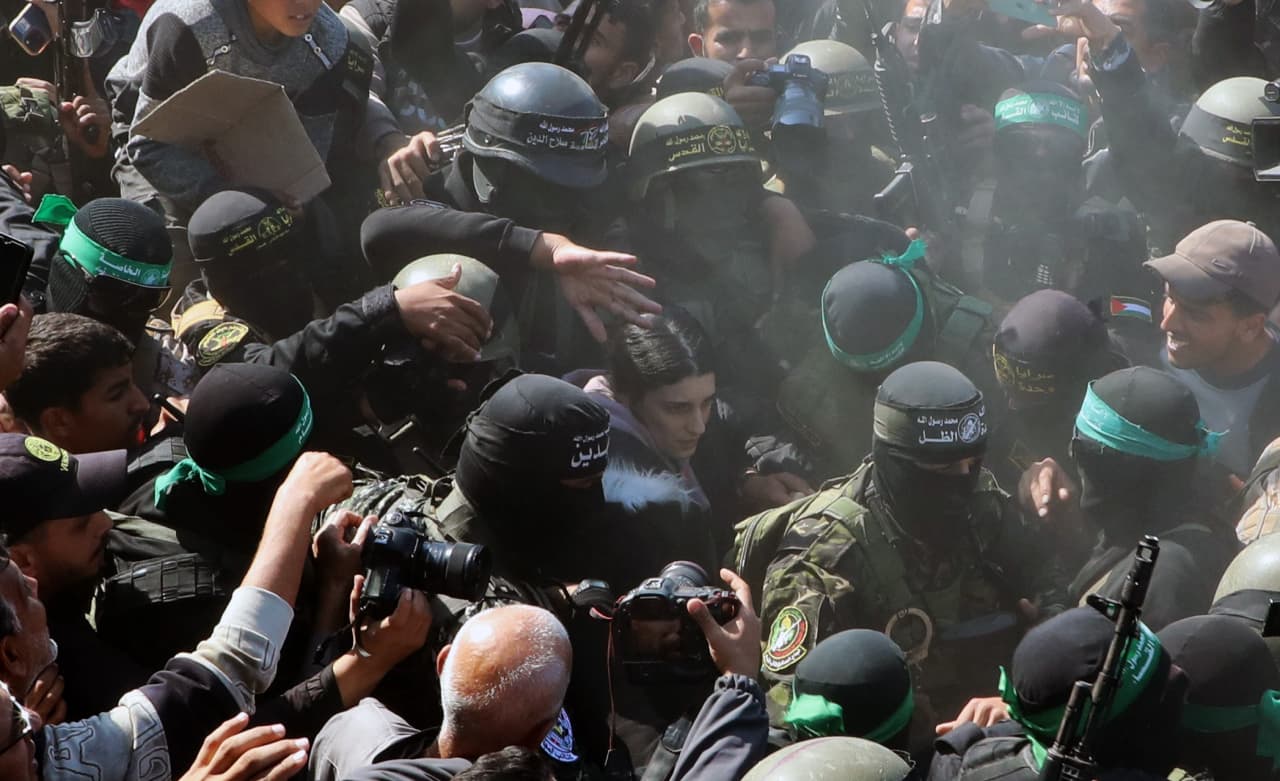 Hamas members Thursday escorted Arbel Yehoud, an Israeli civilian, through the crowd in Gaza to Red Cross workers.