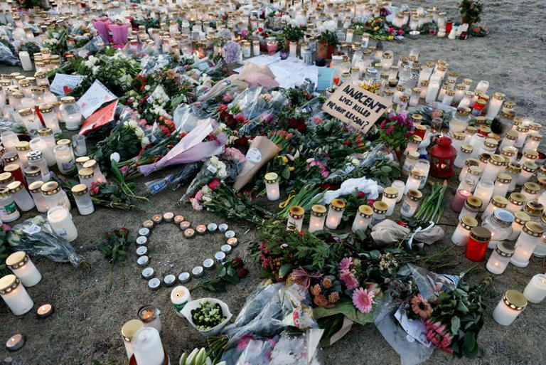 Candles and flowers are placed near the Risbergska school, following a deadly shooting attack at the adult education centre, in Orebro, Sweden, February 7, 2025. REUTERS/Kuba Stezycki