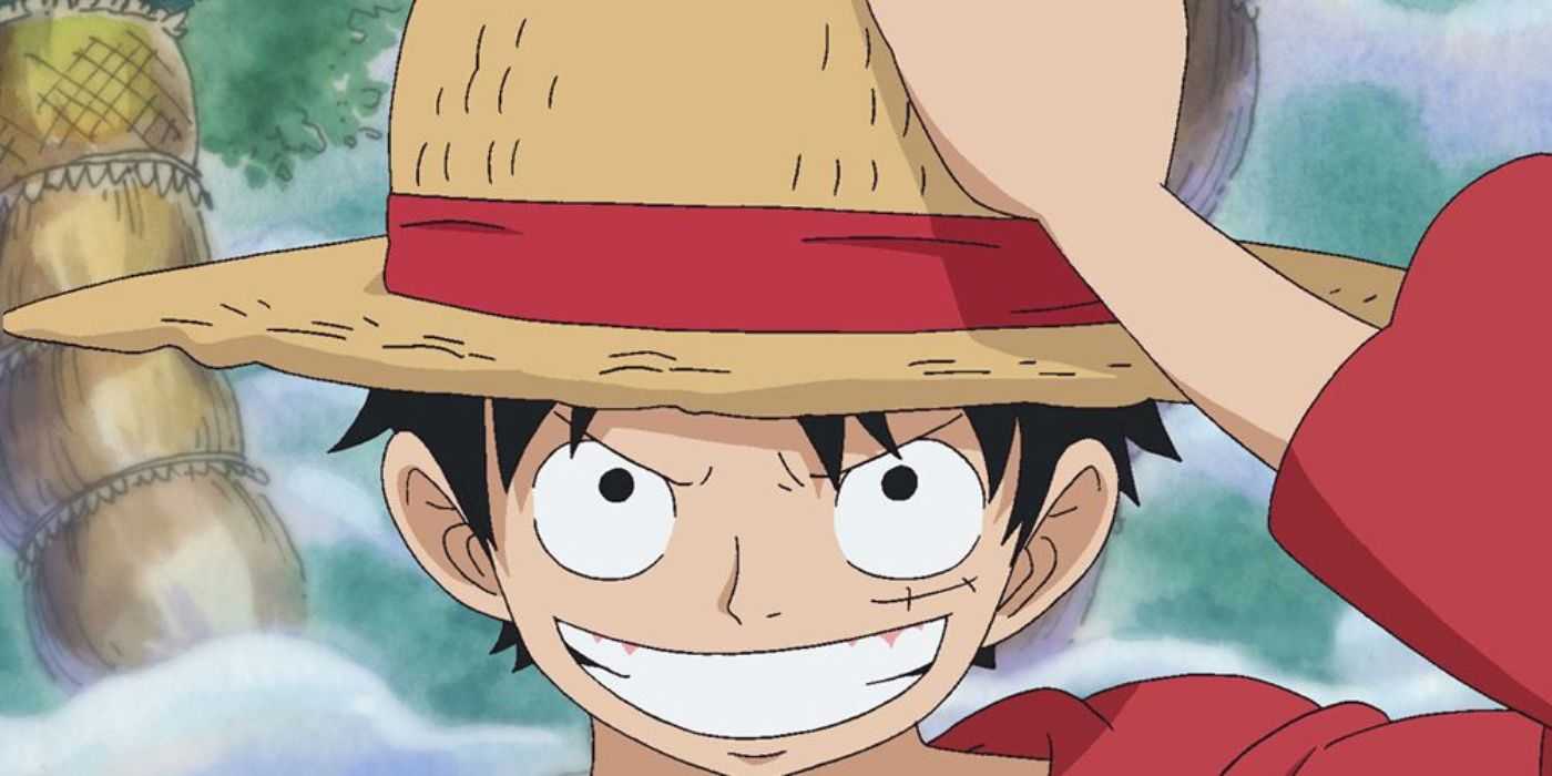 A grinning Monkey D. Luffy dons his iconic straw hat in the Return to Sabaody Archipelago arc in the One Piece anime.