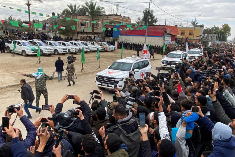 A Red Cross convoy arrives in Deir al-Balah, Gaza, to collect the three hostages released Saturday.