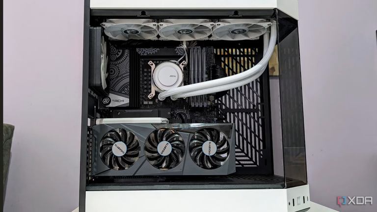 An image showing a completed PC build in a white case with the side panel off showing the components inside
