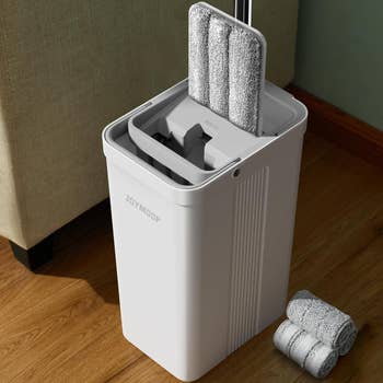 Mop with integrated cleaning system inside a bucket