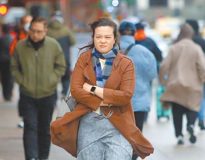 中央氣象署8日持續針對全台20縣市發布低溫特報，台北市街頭民眾穿上保暖衣物禦寒。（趙雙傑攝）
