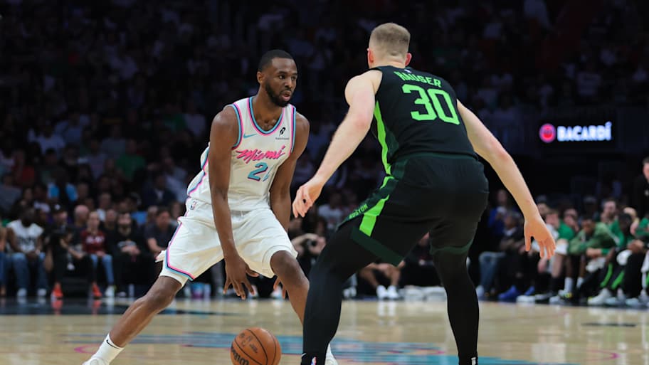 Feb 10, 2025; Miami, Florida, USA; Miami Heat forward Andrew Wiggins (22) dribbles the basketball as Boston Celtics forward Sam Hauser (30) defends during the second quarter at Kaseya Center. Mandatory Credit: Sam Navarro-Imagn Images | Sam Navarro-Imagn Images