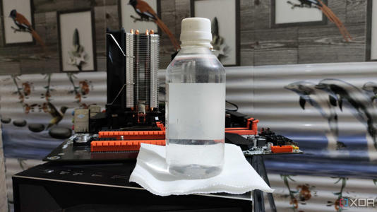 A bottle of isopropyl alcohol lying near a dual-Xeon X99 motherboard