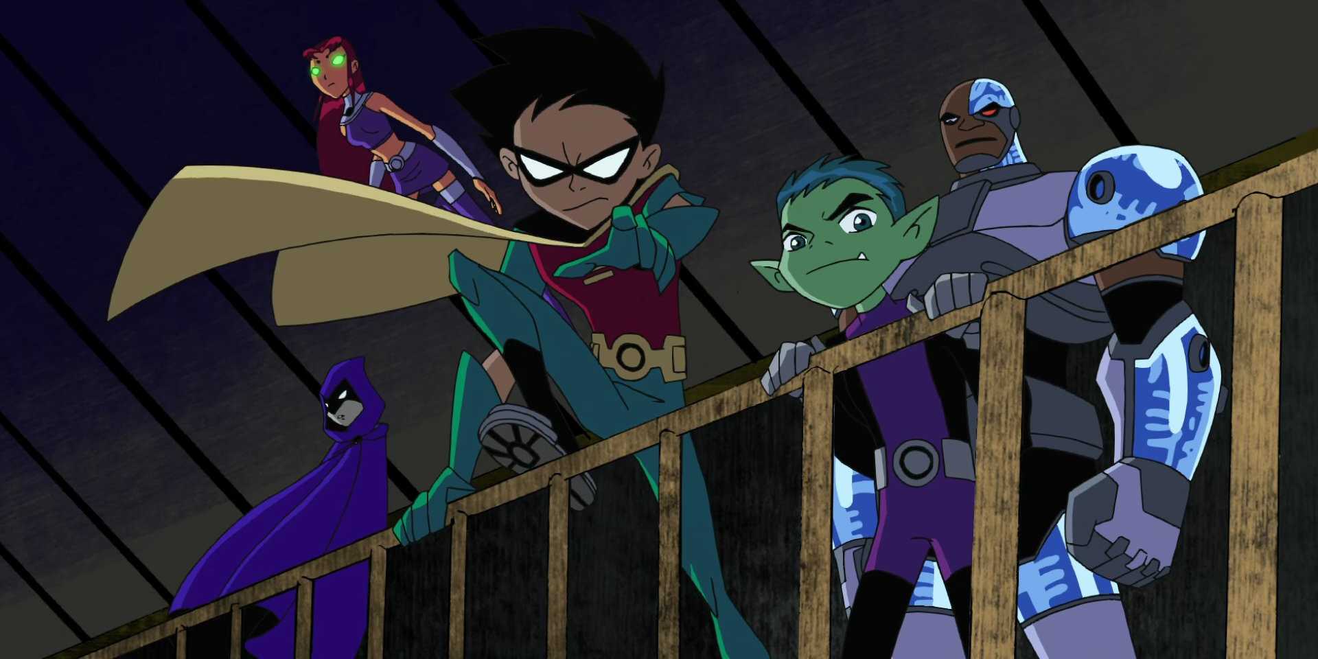 The Teen Titans standing behind fence
