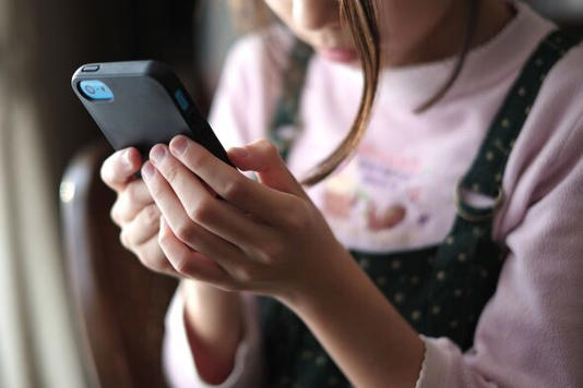 Kid looking at smartphone