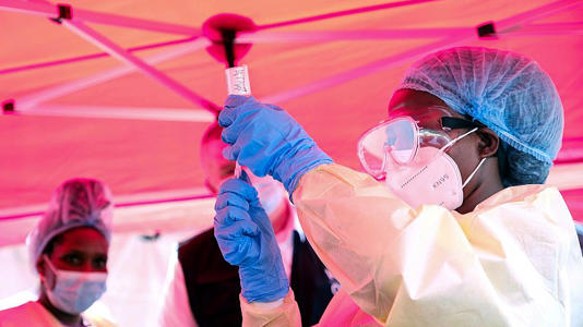 A health worker prepares to administer a vial of a vaccine against the Sudan strain of Ebola, during a trial, at Mulago Referral Hospital, in Kampala, Uganda.