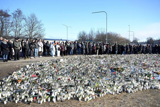 FILE PHOTO: People gather for a national minute of silence for the victims of the Risbergska School shooting that took place on February 4, at a memorial site in Orebro, Sweden, February 11, 2025. TT News Agency/Jessica Gow via REUTERS/File Photo