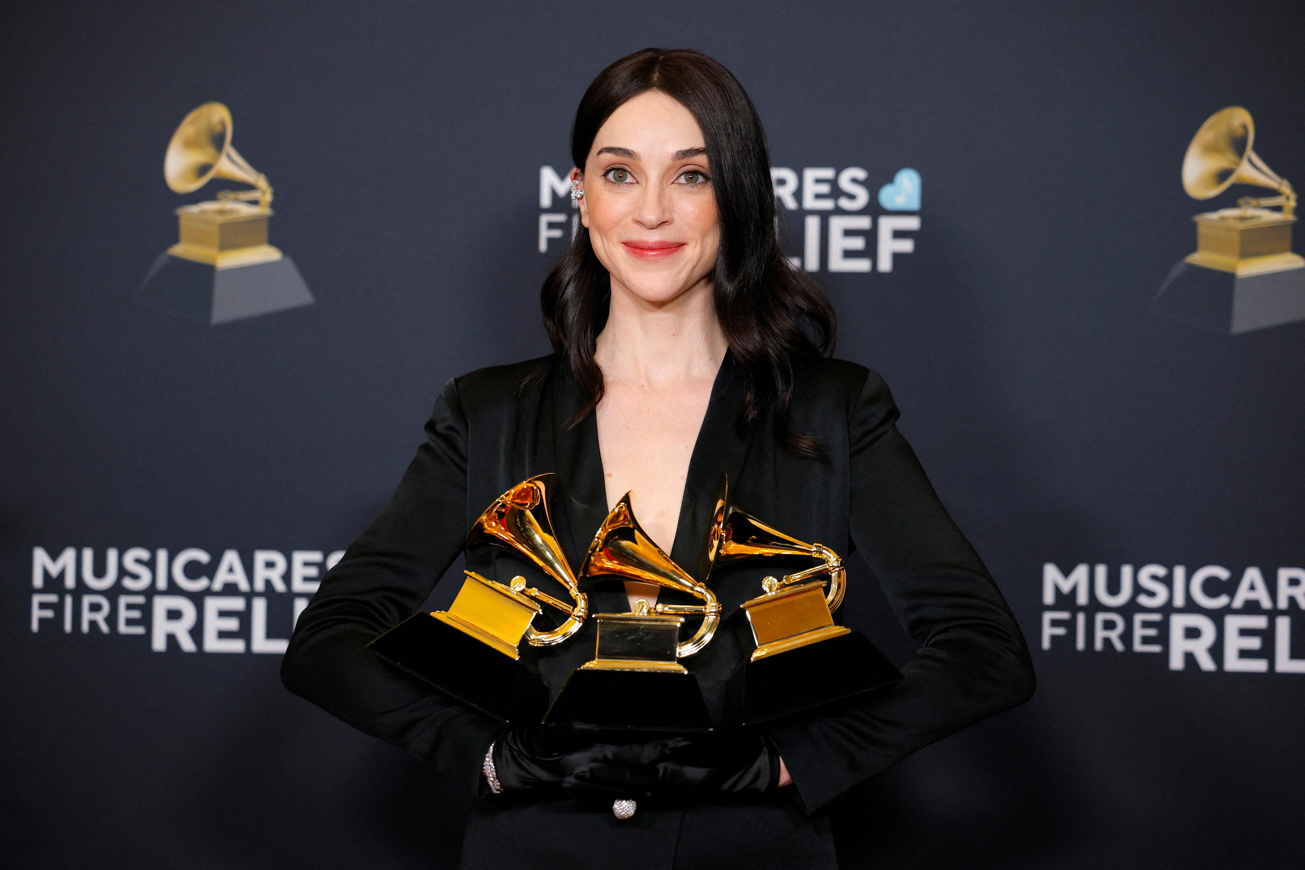 St. Vincent poses with her trophies for best rock song, best alternative music performance and best alternative music album during the 67th annual Grammy Awards in Los Angeles on Feb. 2, 2025.
