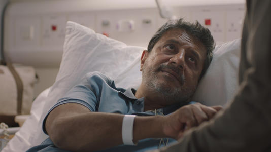 Kareem (Ravin J. Ganatra) undergoes emergency surgery. (Image credit: BBC Studios. )