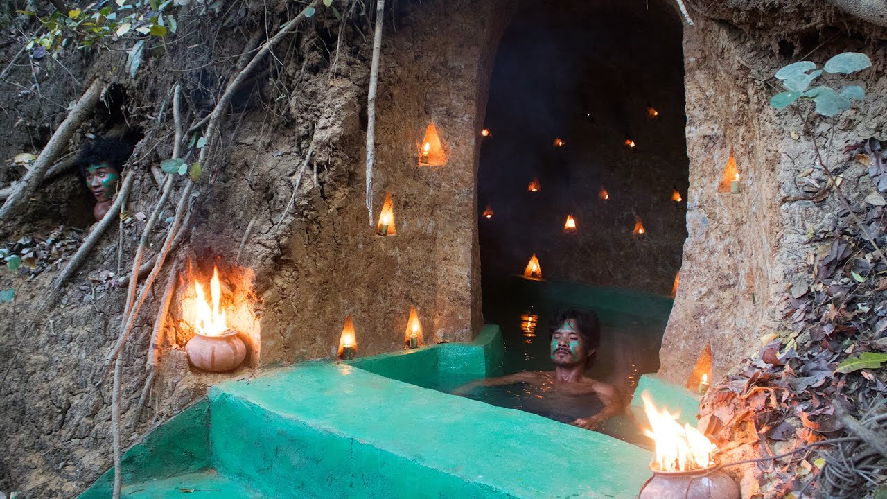 Builders add a swimming pool to a hand-built mud home