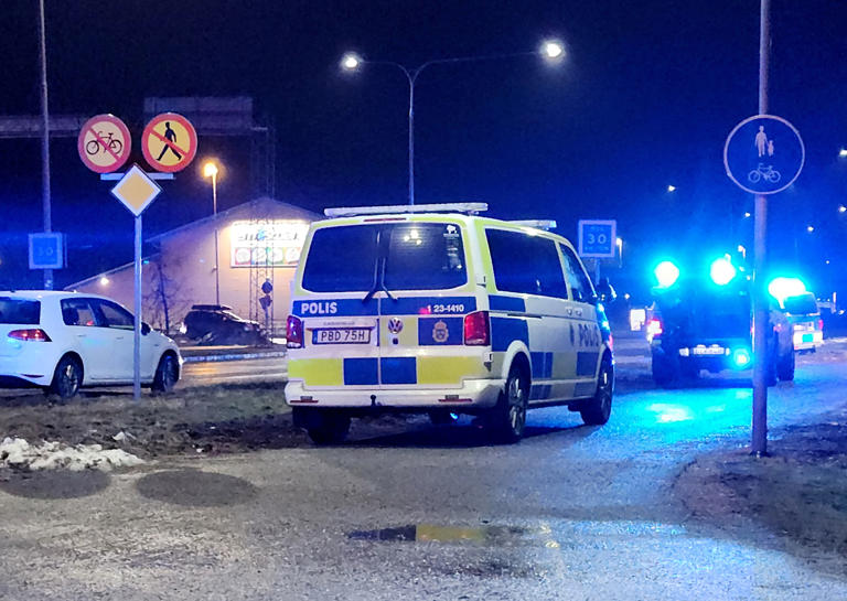 Police cars pass near the adult education center Campus Risbergska school after a shooting attack in Orebro (Reuters)