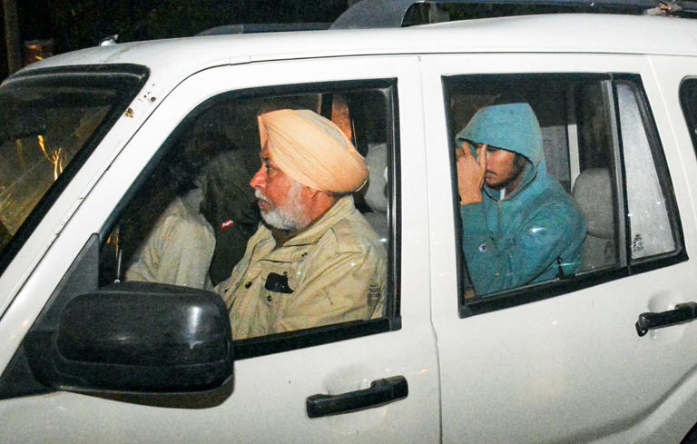 Amritsar, Feb 05 (ANI): Police escort away an Indian immigrant who was deported from the US through a C-17 US military aircraft, at Sri Guru Ram Dass Jee International Airport in Amritsar on Wednesday. (ANI Photo) 