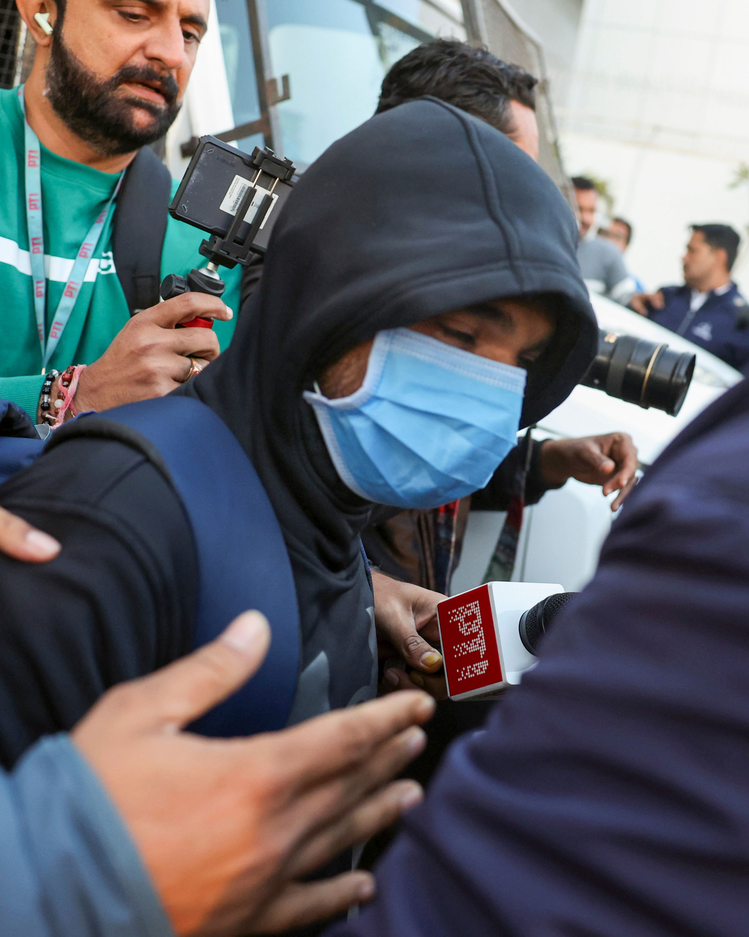 Ahmedabad: A Gujarat native deported from US is being brought to the Ahmedabad airport, Thursday, Feb. 6, 2025. A US military plane brought 104 deported Indians to Amritsar on Wednesday. (PTI Photo)(PTI02_06_2025_000052A)