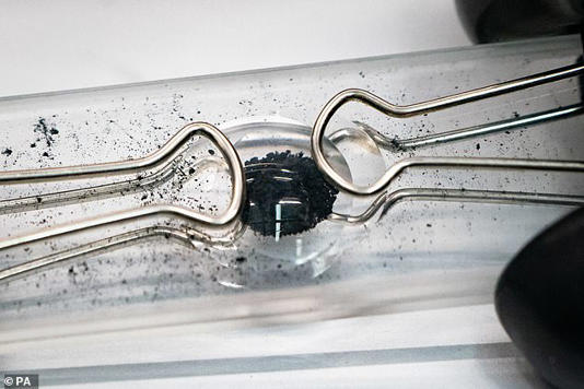 If Bennu contains a large amount of iron, it could actually help marine ecosystems flourish by effectively fertilising the oceans. Pictured: A sample of Bennu prepared for testing