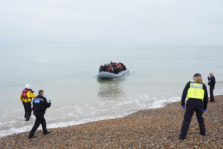 Police and Border Force officers wait to intercept a dinghy carrying people, thought to be migrants, off the coast of Dungeness, Kent (PA Archive)