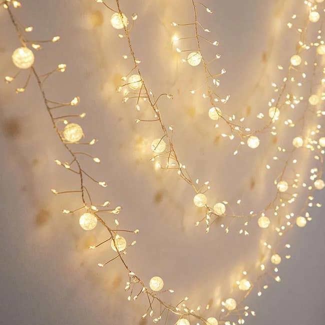 String lights hanging on a wall, creating a cozy and decorative ambiance, suitable for home decor or events
