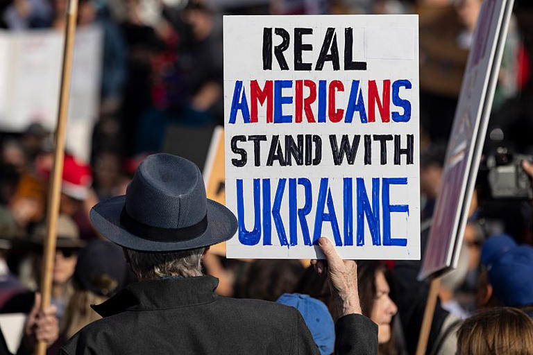 A demonstrator holds a poster during a rally in Los Angeles to protest President Donald Trump's policies, 17 February, 2025 AP Photo