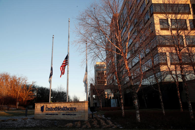 Flags fly at half-staff outside UnitedHeathcare’s headquarters after CEO Brian Thompson was fatally shot. (REUTERS)