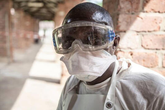 Health worker outside the isolation ward