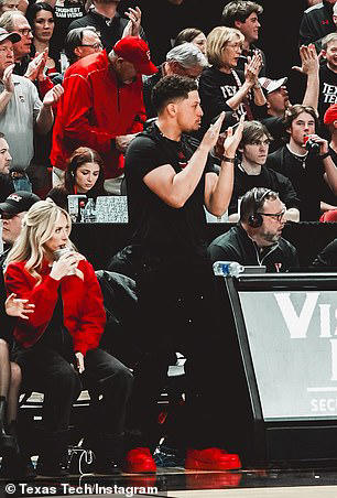 He sat courtside with his wife Brittany