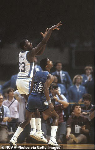 North Carolina freshman Michael Jordan (23) sinks the shot to win the NCAA Photos via Getty Images National Basketball Championship game held at the Superdome in New Orleans, LA. Georgetown's Eric Smith (32) can only watch the ball hit its mark