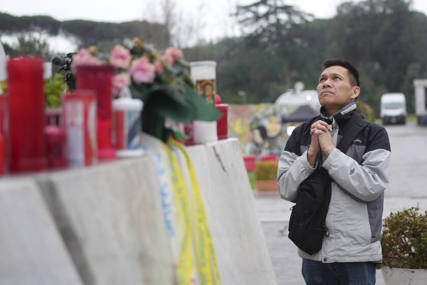 Hoang Phuc Nguyen prays for Pope Francis outside Gemelli hospital in Rome. ((Alessandra Tarantino / Associated Press))