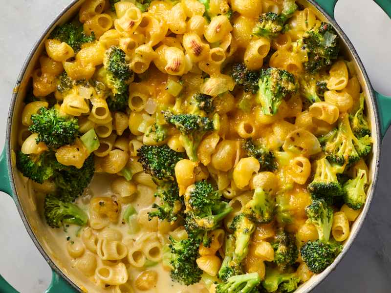 overhead shot of creamy broccoli pasta bake in a teal pot