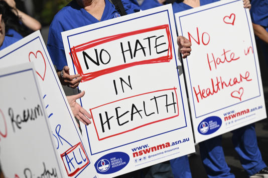 Nurses and medical professionals staged a rally against against hate speech, in Sydney (AAP Image via AP)