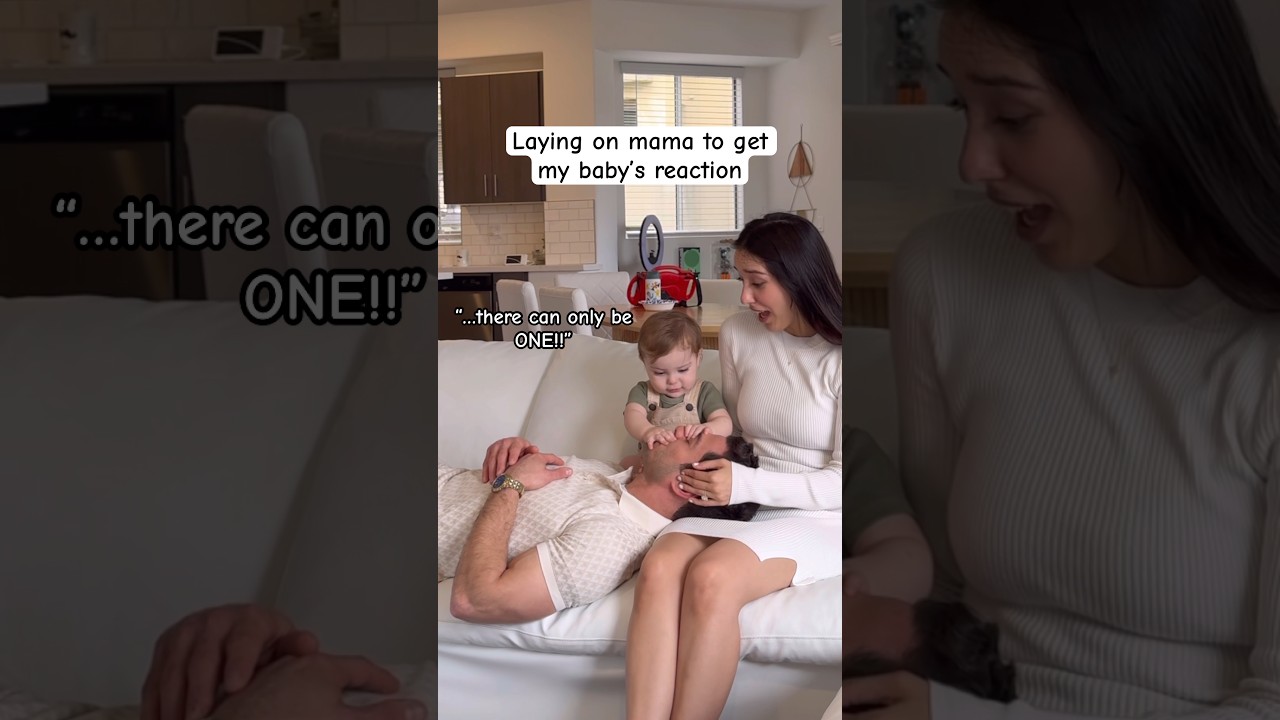 Dad lays on mom to see a priceless reaction from the baby