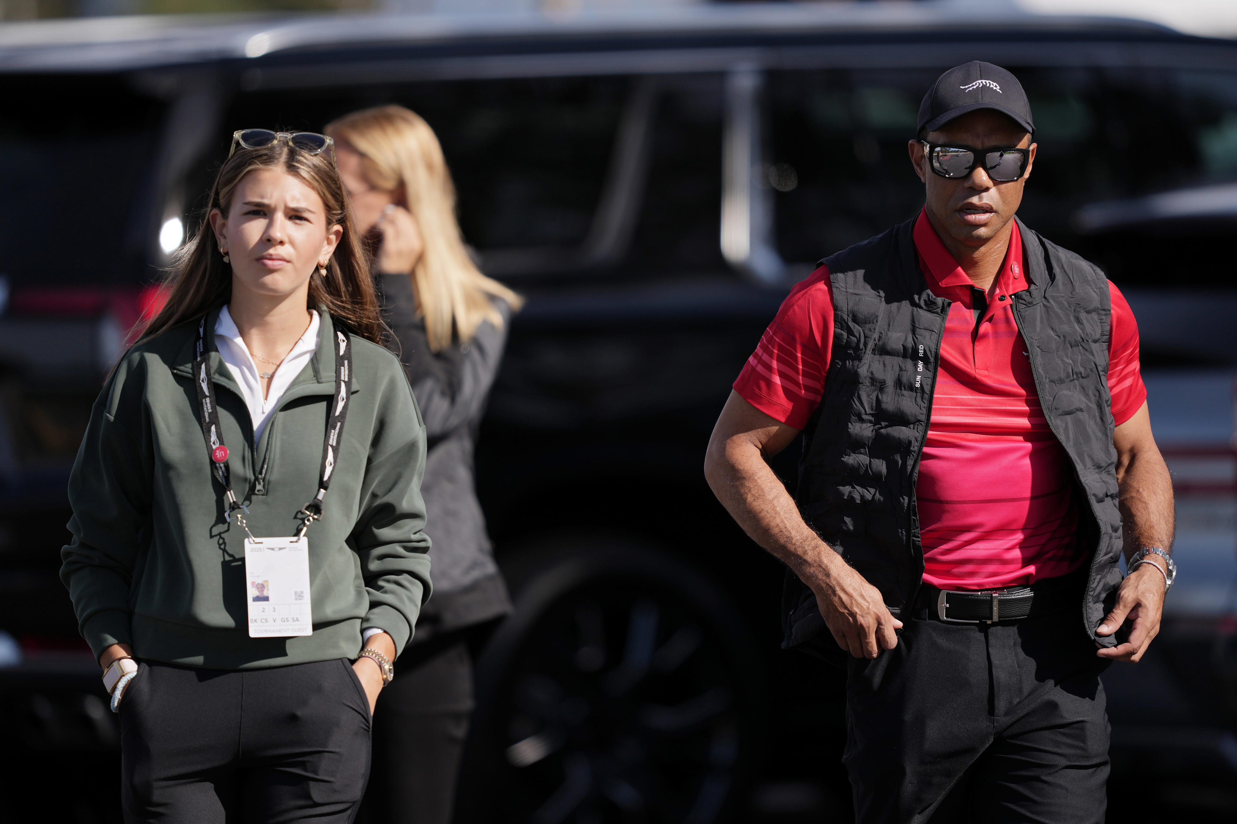 Kai Trump and Tiger Woods arrive at Torrey Pines during the final round of the 2025 Genesis Invitational.