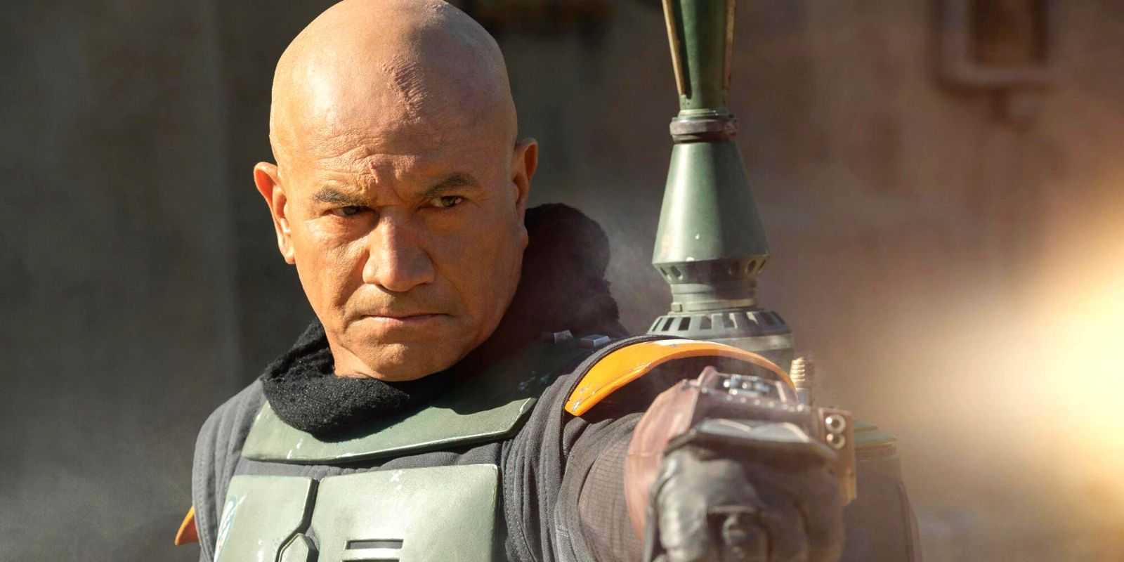 Boba Fett (Temuera Morrison) uses his wrist launcher in Star Wars: The Book of Boba Fett.