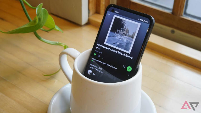 spotify on phone screen as phoe sits in coffee cup