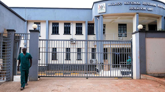 A health worker walks outside Mulago Referral Hospital in Kampala, Uganda Tuesday, Feb. 18, 2025