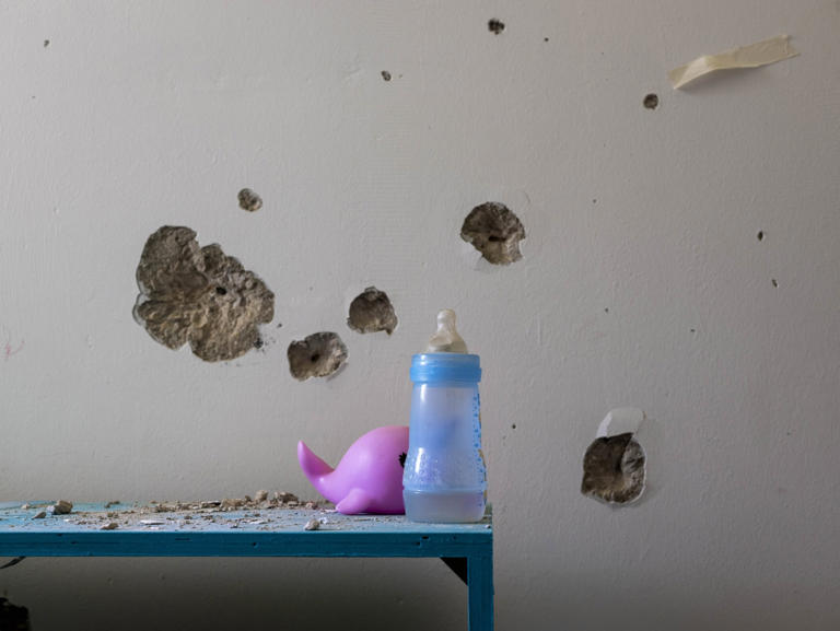 Bullet holes on the bedroom wall of Ariel Bibas in Nir Oz.