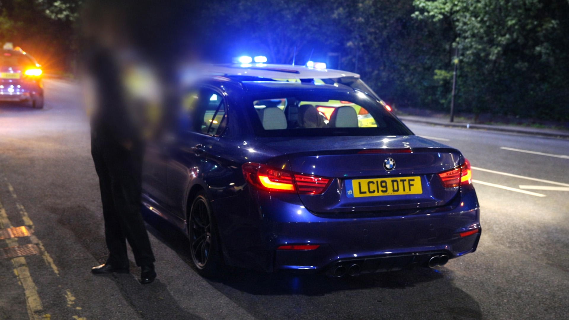 BMW M4 stopped by police with lights flashing