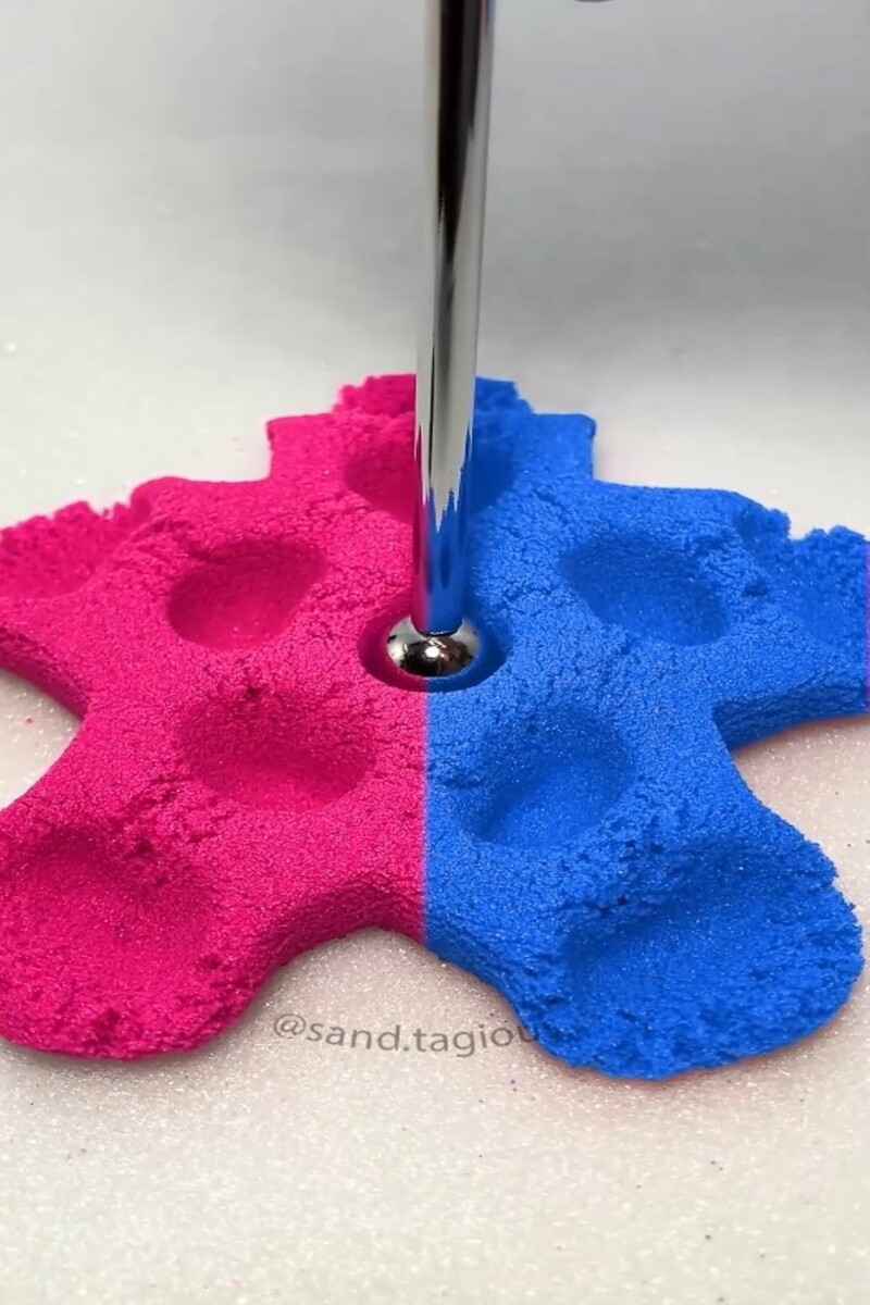 Pressing colorful kinetic sand with metal tool